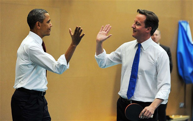 Barak Obama and david cameron giving hi5